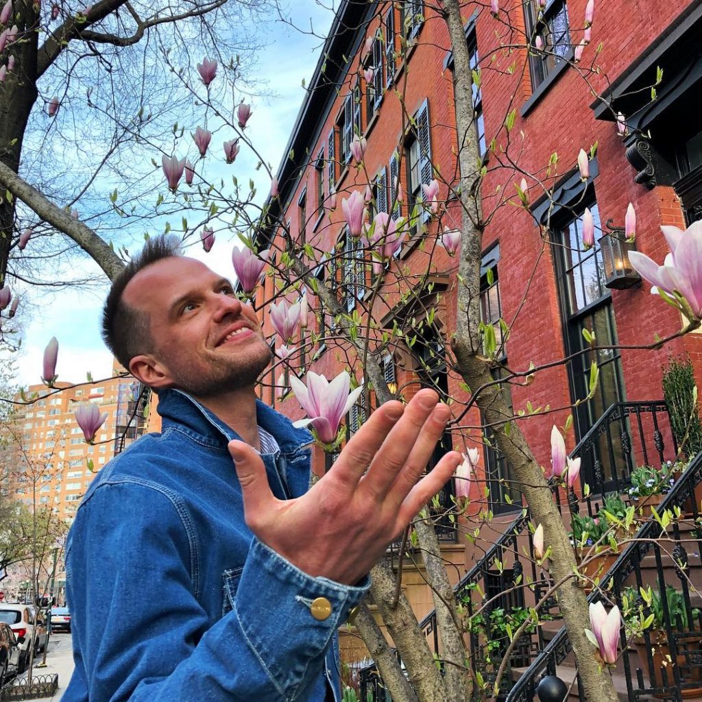 Philippe von Borries looking happy while being surrounded by flowers.