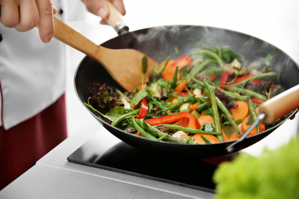 Mixing vegetables in pan closeup