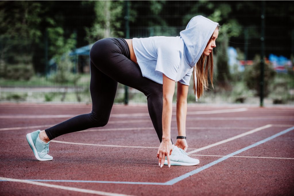 Fitness girl is preparing to run from a low start perfect for nike women's air vapormax.