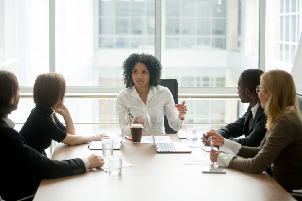 Businesswoman having a meeting with her subordinates. A female leader is a good symbol of women's equality day.