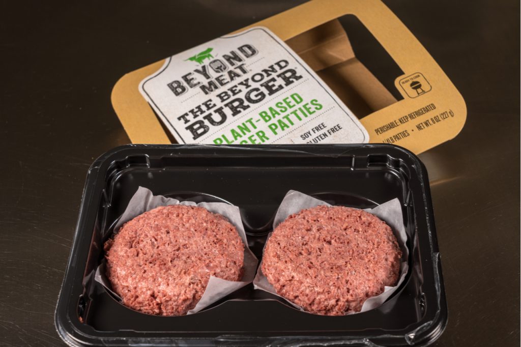 An opened box of beyond meat burger patties showing the contents of 2 burger patties inside.