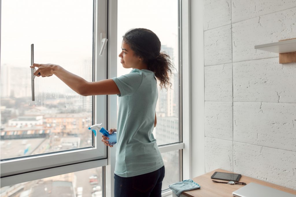 Woman cleaning window.