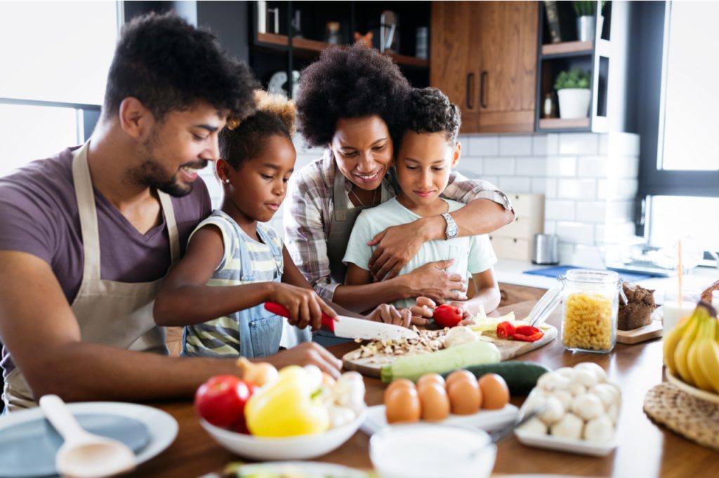 Happy family in the kitchen having fun and cooking together.