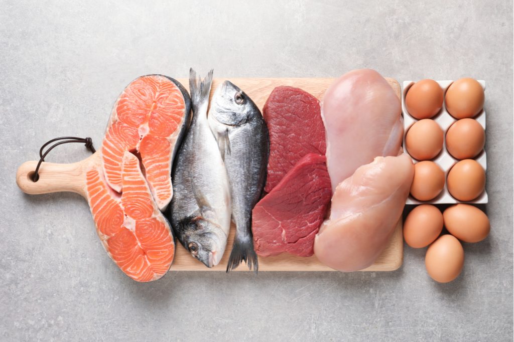 Set of natural food high in protein on grey background, top view.