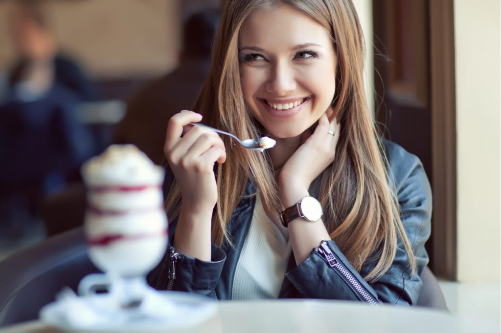 Woman eating realgood super premium mocha java chip ice cream.