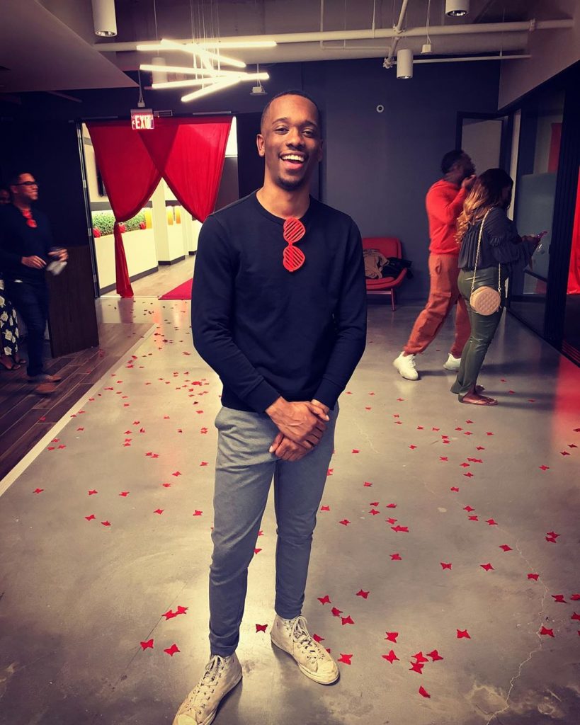Scooter Taylor wearing a black long-sleeved shirt at a party with lots of confetti on the floor.