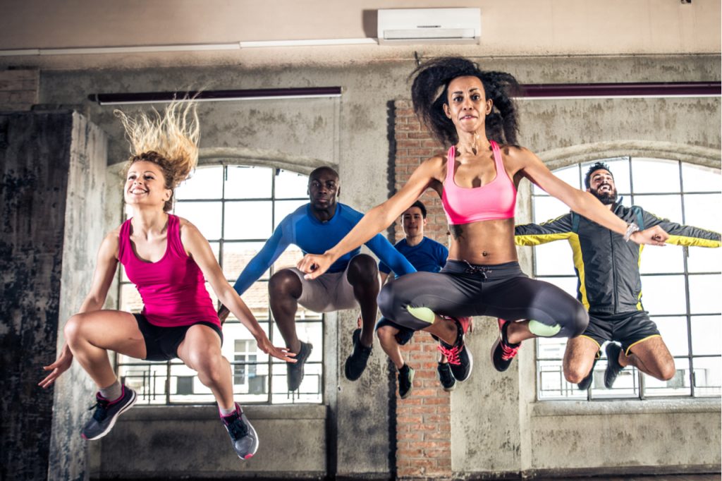 Group of sportive people training in a gym.