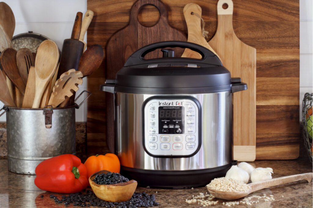 nstant Pot pressure cooker on kitchen counter with beans and rice.