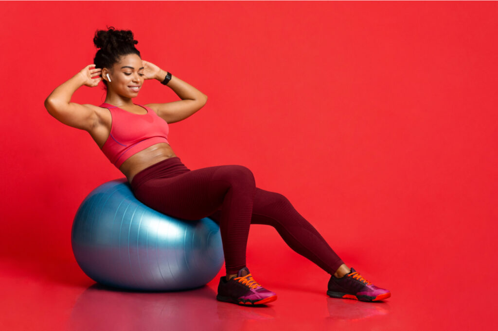 Woman working out with fitness ball.