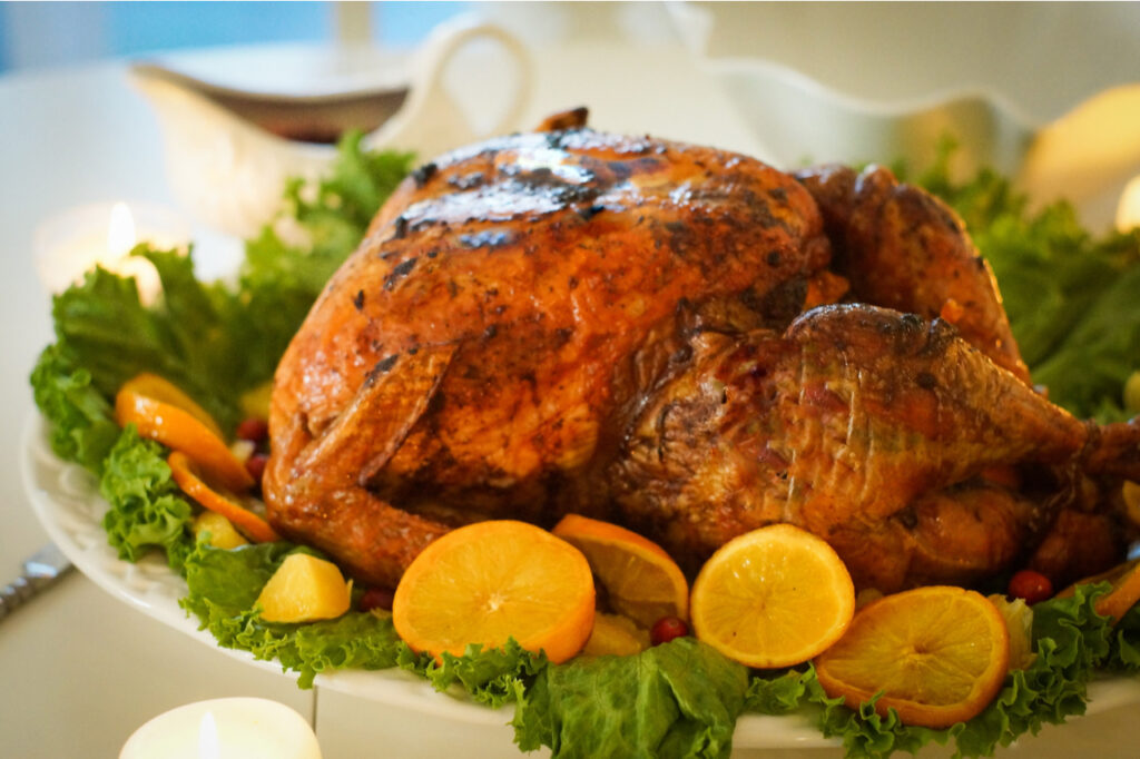 Roasted Turkey with leaves, lemons, and oranges for Christmas.