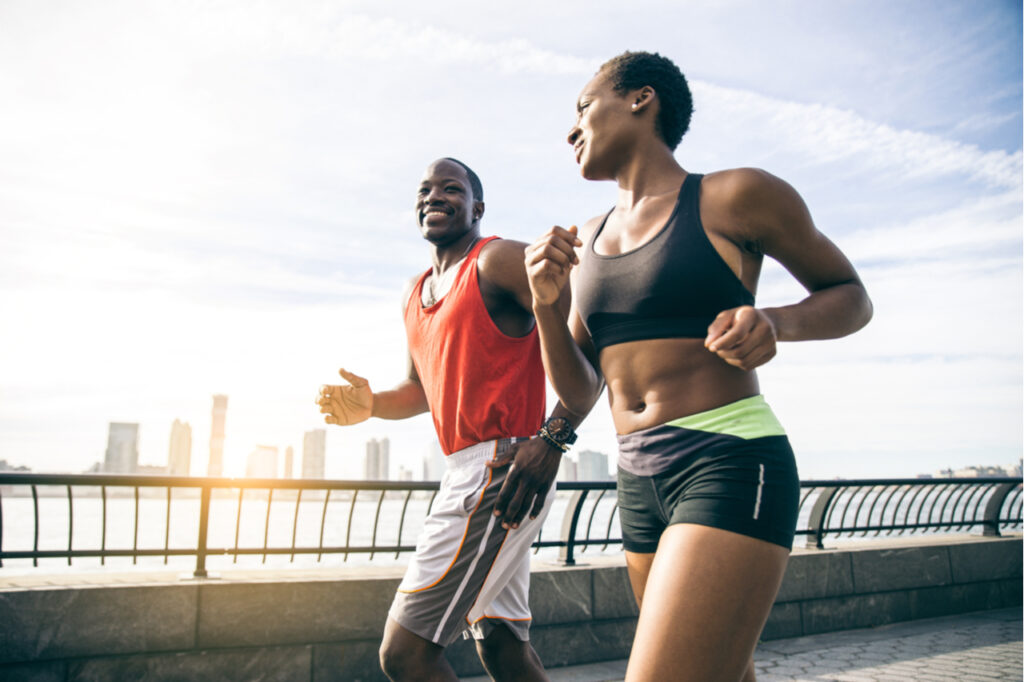 Couple running in New York - Sportive man and woman training outdoors