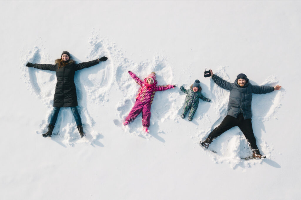 Family making a snow angel.