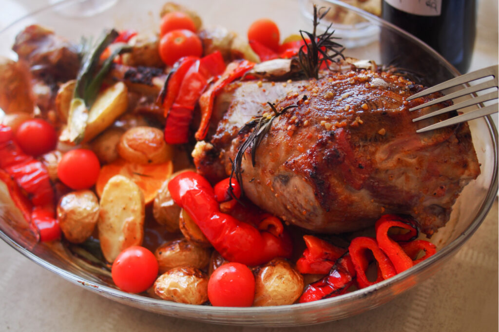 Roasted meat leg of lamb with potatoes.