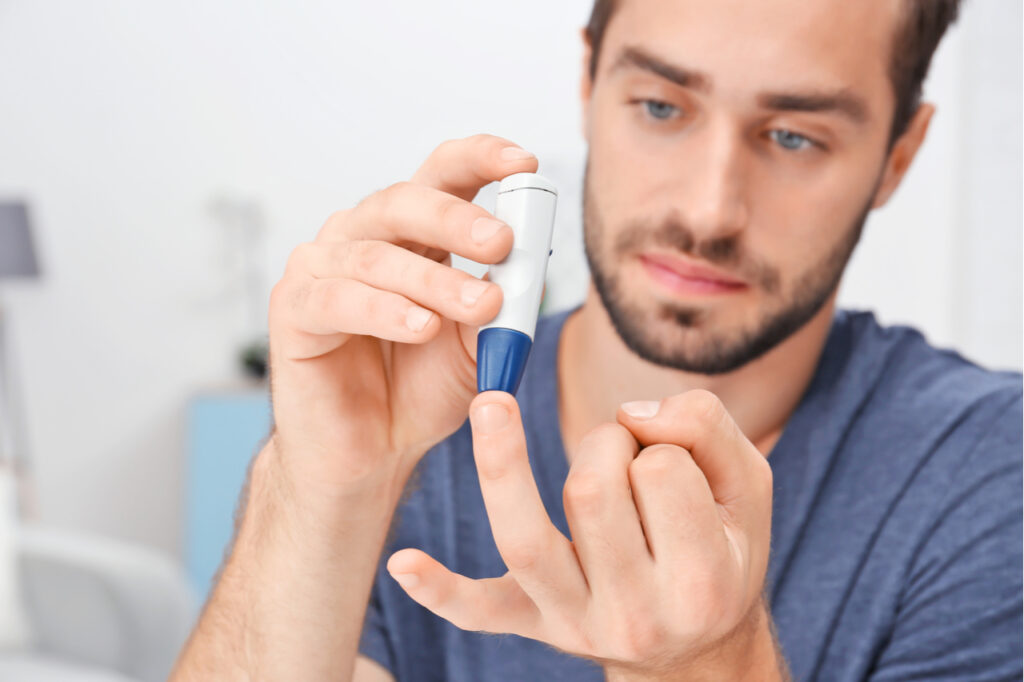 Man checks sugar level for diabetes prevention.