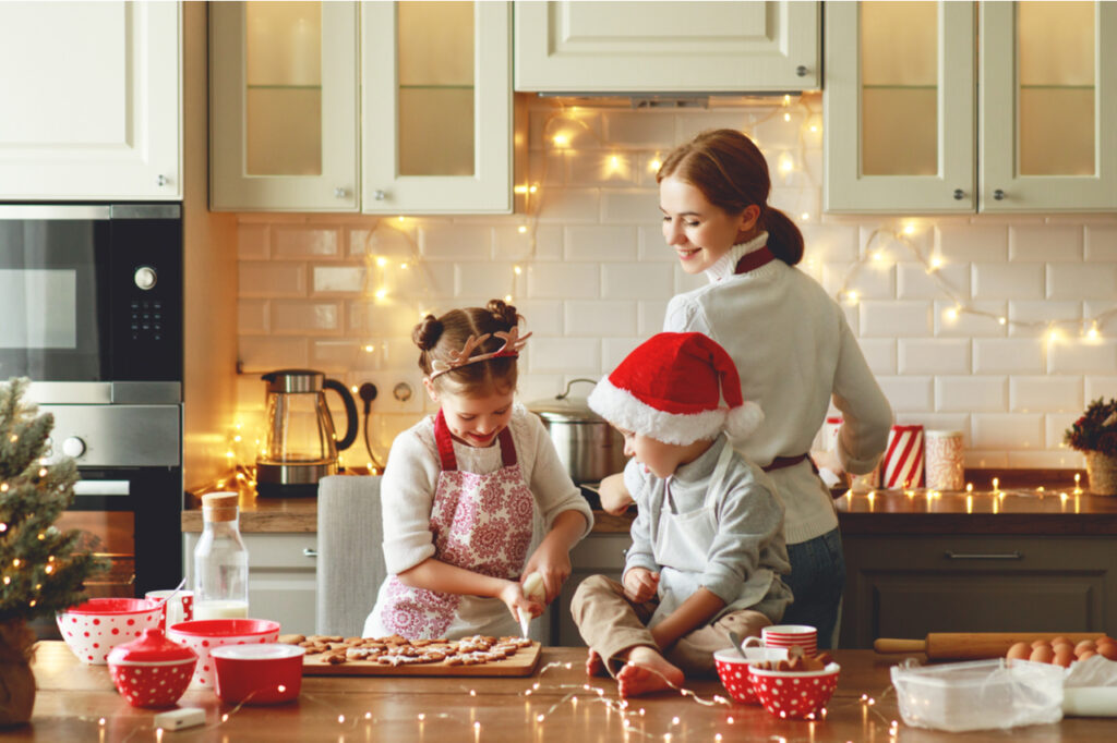 Mother and children bake christmas cookies.