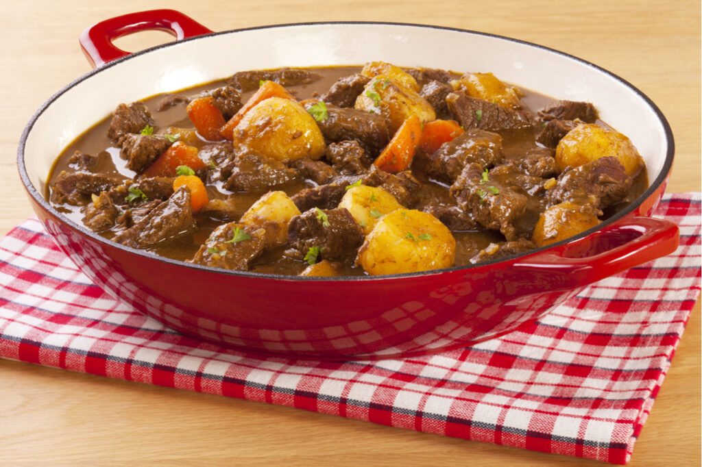 Beef stew with carrots and potatoes - a simple stew in a red pot.