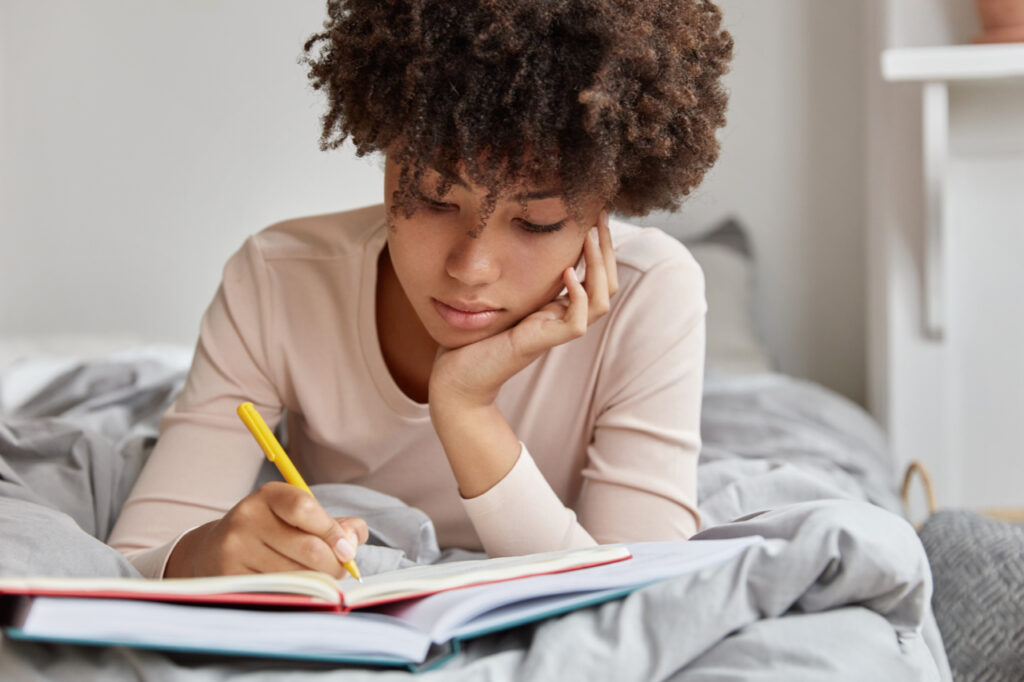 Woman writing in a journal.