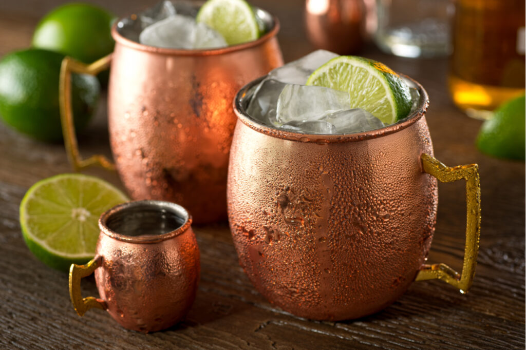Moscow mules in 2 copper mugs with sliced lime, the best winter cocktail.