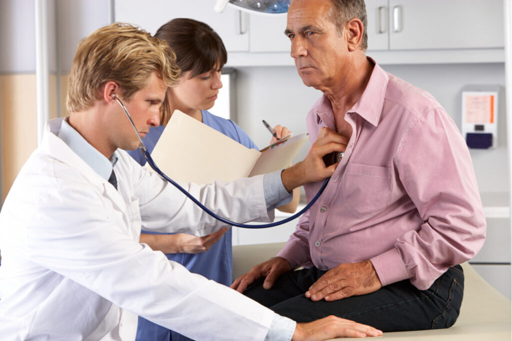 Doctor listening to patient's chest.