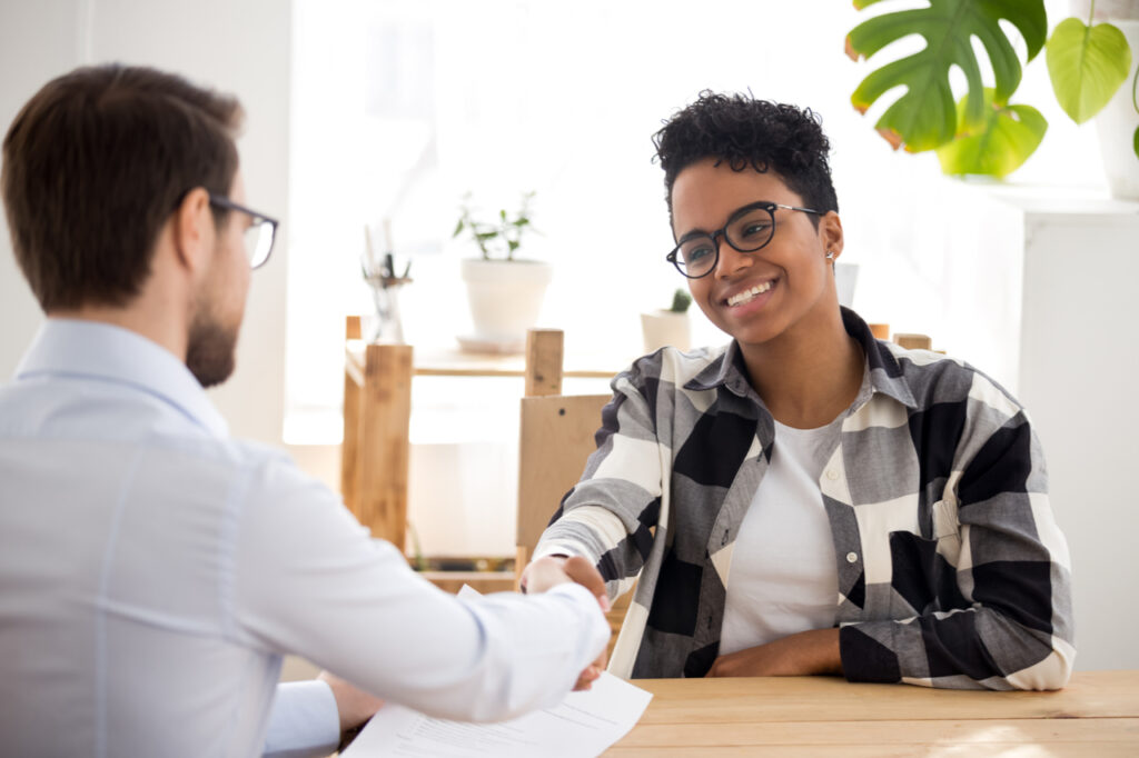 Happy confident applicant shaking hand of hr manager offer new job.