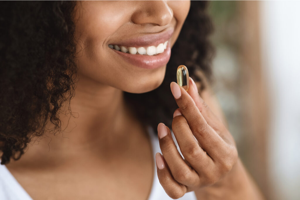 Woman taking EBYSU L-Carnitine Tartrate Maximum Strength Capsule.