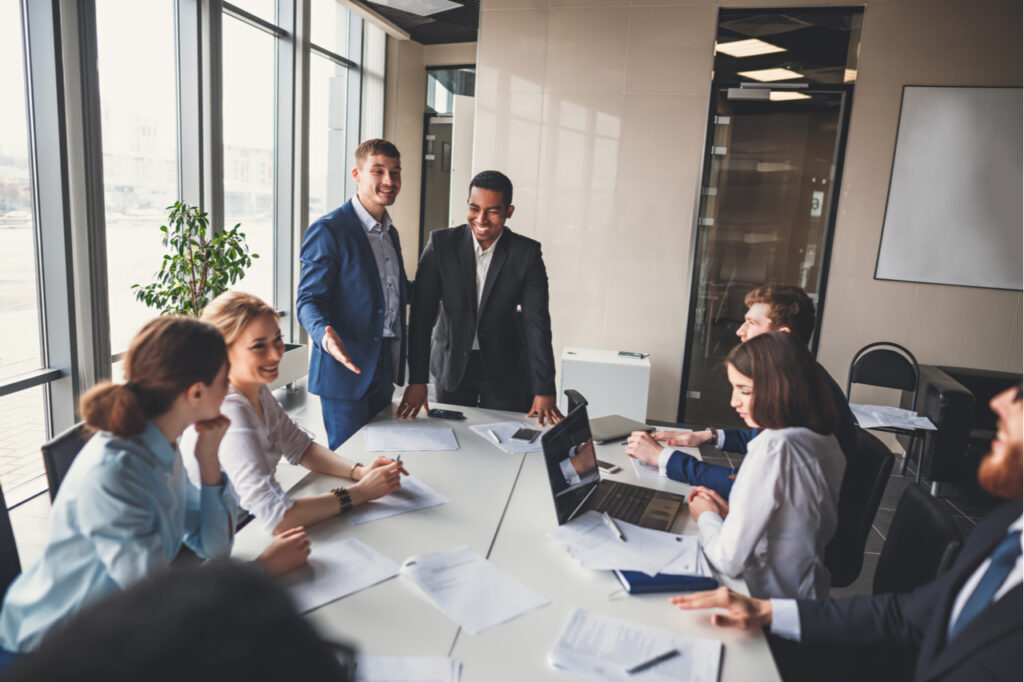 Man in full suit in a meeting showing confidence and charisma after reading the charisma myth book.