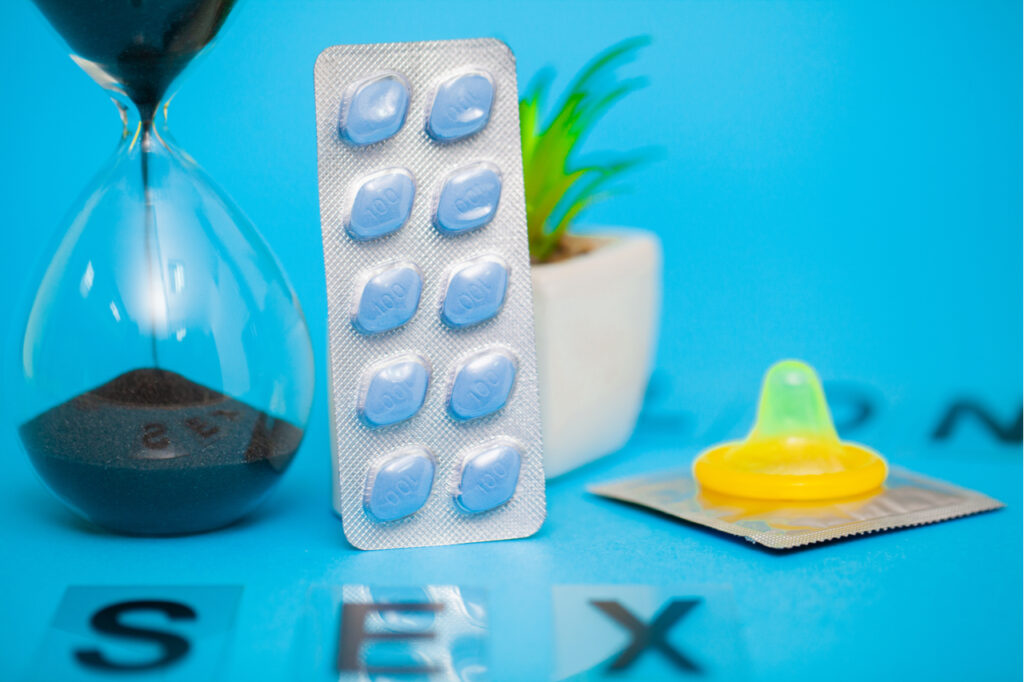 Pills that promote sexual health for men for a long time on blue background