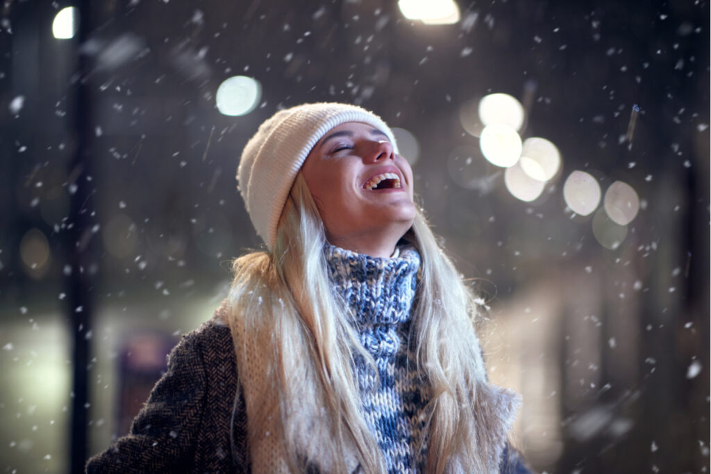 Portrait of a woman walking outside in winter taking breaths.