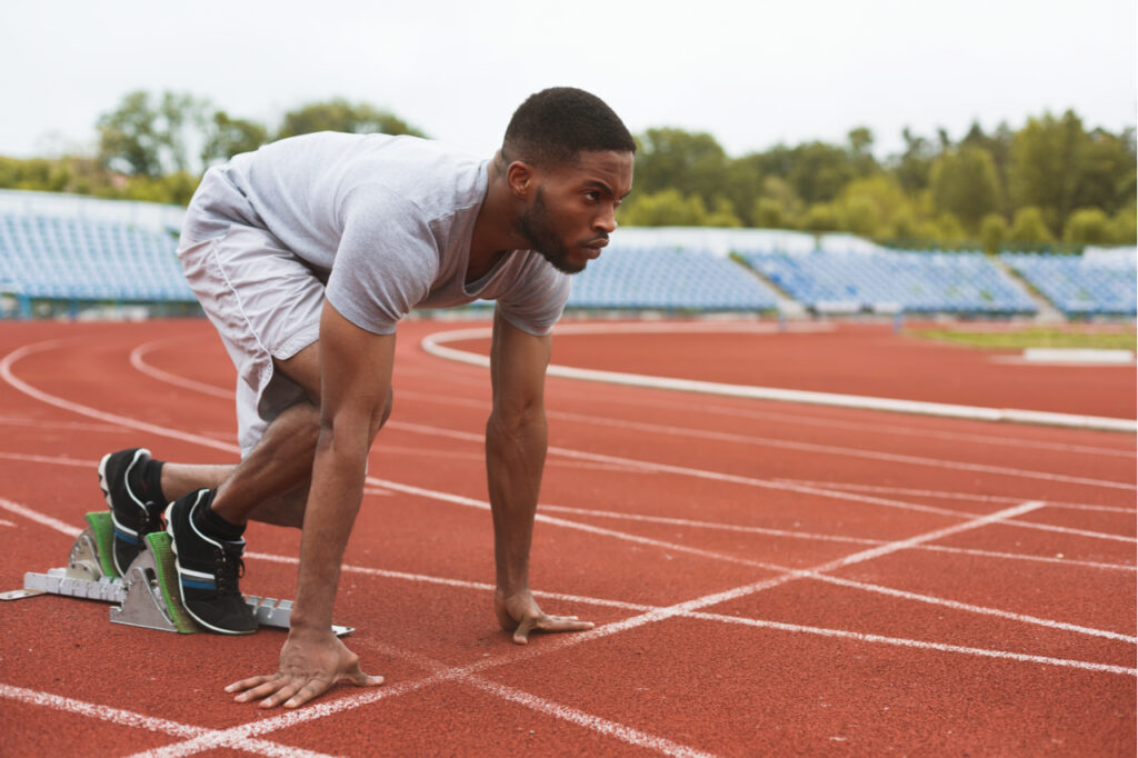 Sportsman on starting position ready to run at the stadium.