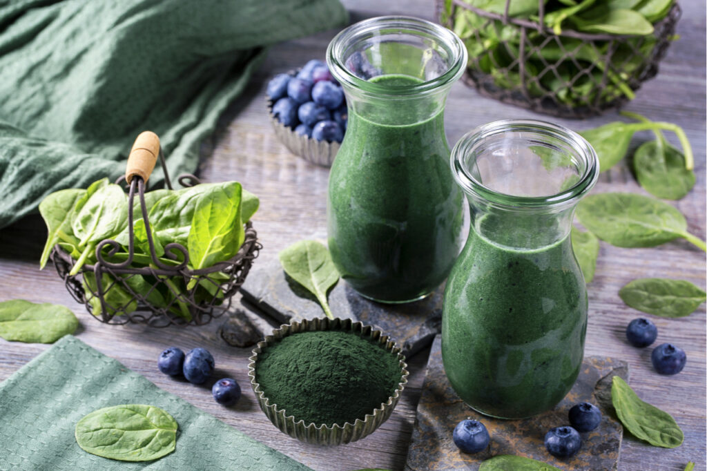 Green smoothie with spirulina, spinach and blueberries.
