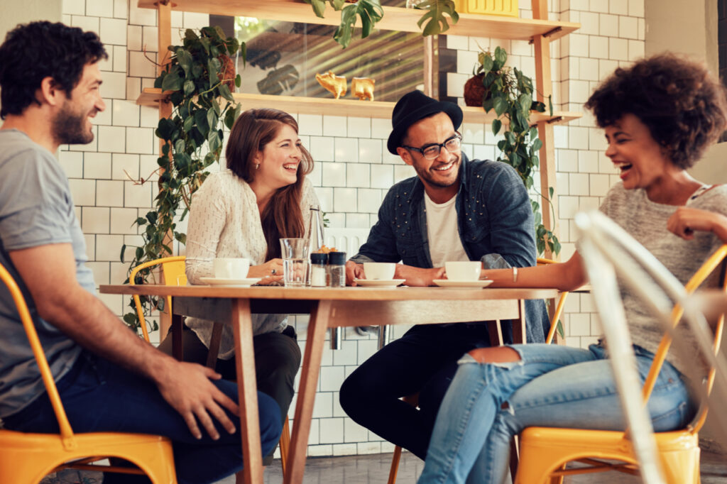 Young people having a great time in cafe that needs to know how to wean off caffeine.