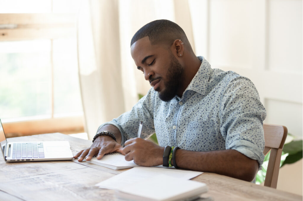 Man writing in a journal.