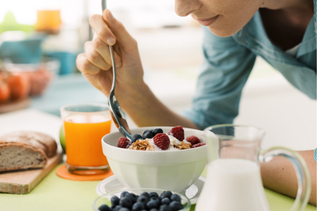 Woman having an healthy delicious breakfast at home as part of multiple sclerosis diet.