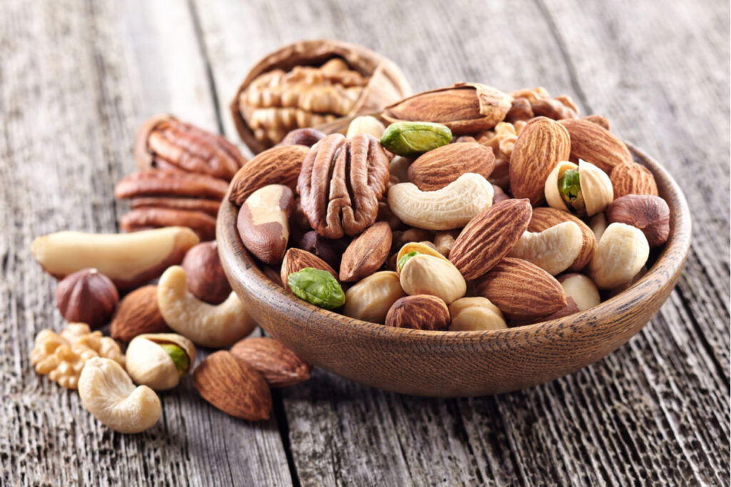 Nuts mix in a wooden plate.