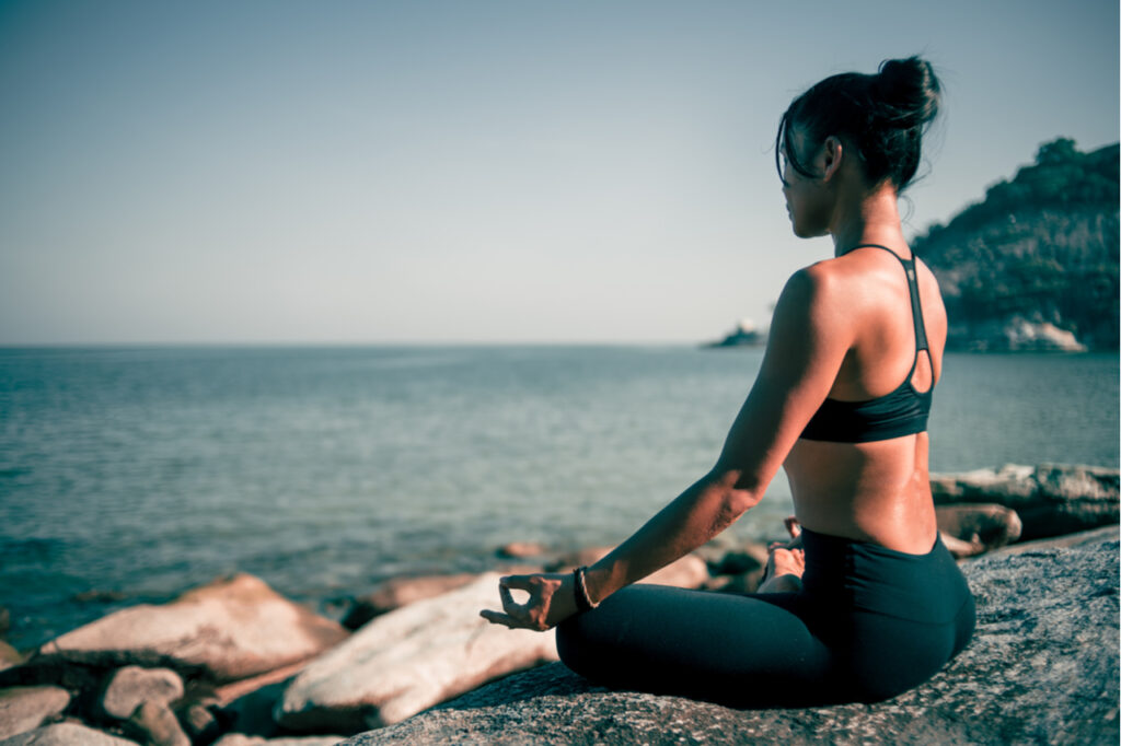 Woman yoga on the beach vintage color.