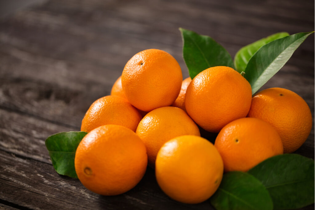 Healthy oranges on a wooden table.