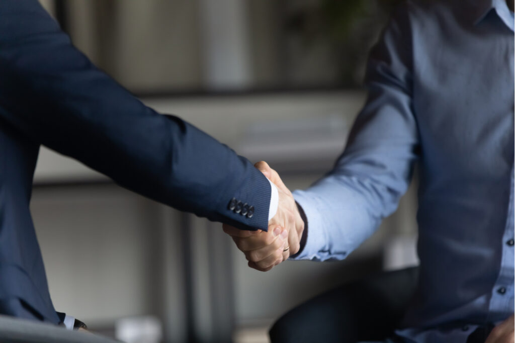 Two businessman shaking hands for closing a deal without free money.