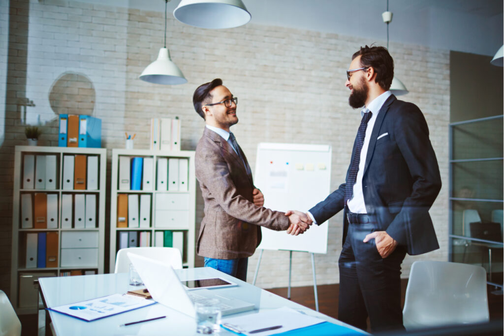 Successful businessmen handshaking after negotiation.