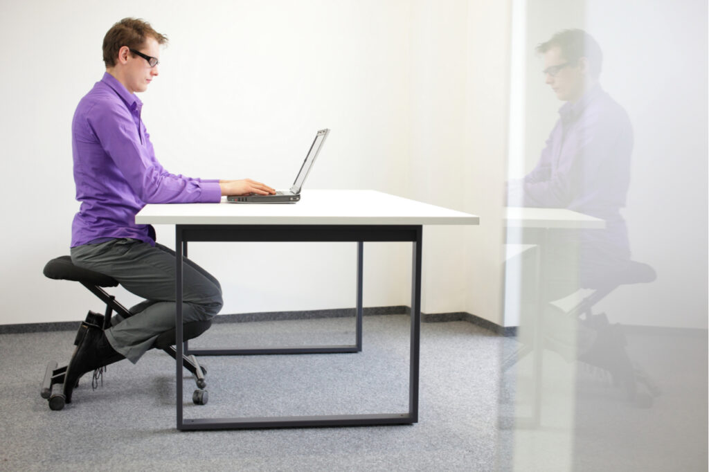 Man in a correct sitting position at workstation.