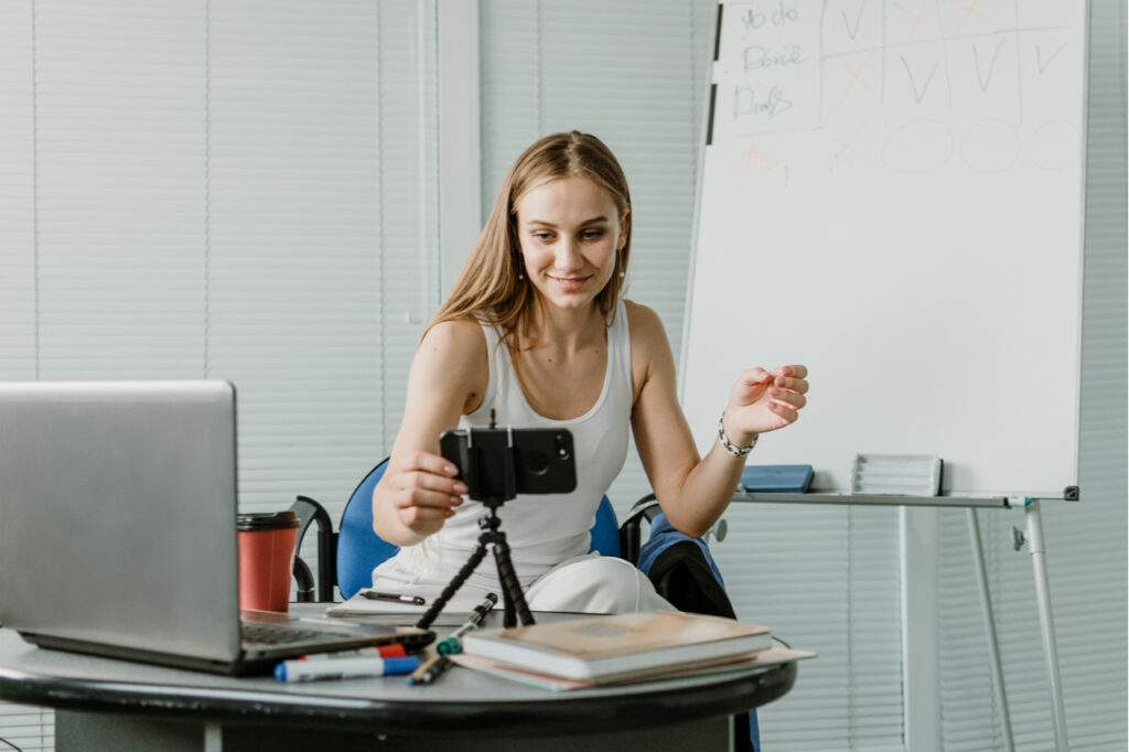 Woman speaking in front of camera for vlog as blogger.