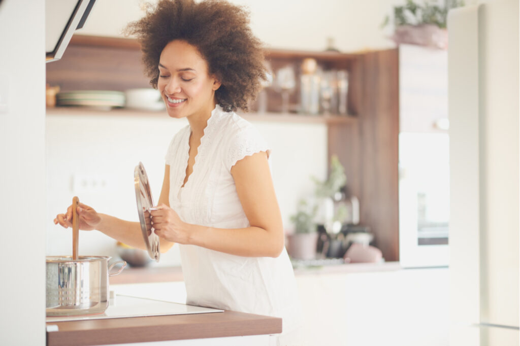 Woman making soup in the kitchen.
