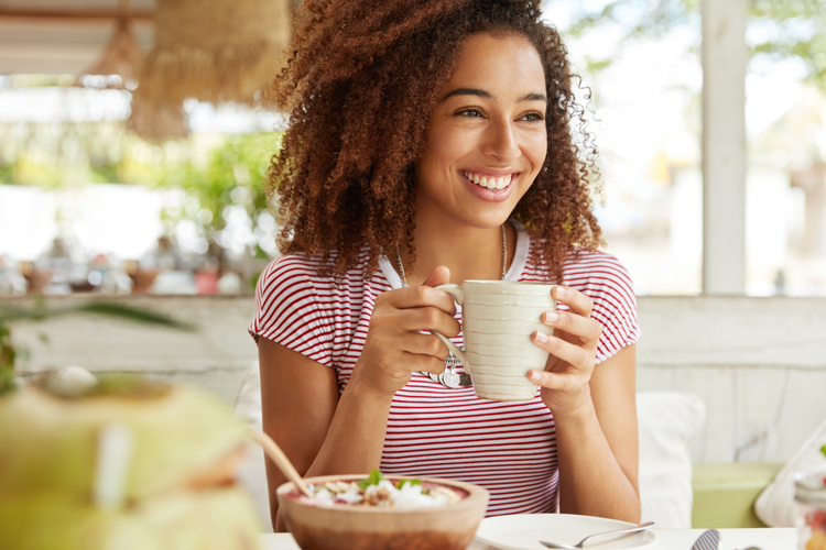 Woman having breakfast happily.