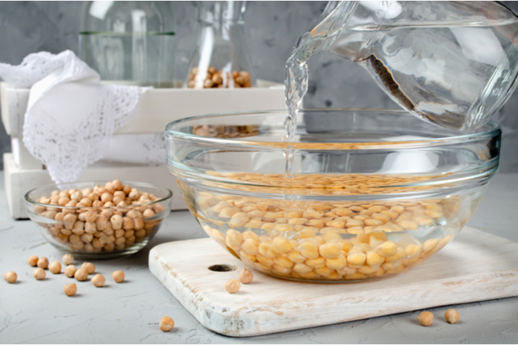 Chickpea soaked in water in a glass bowl.