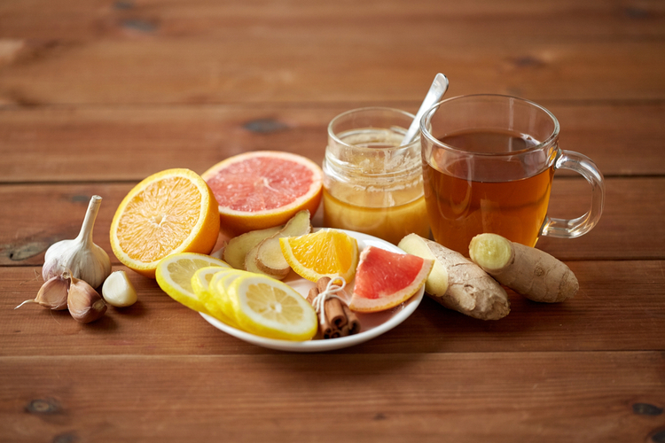 ginger, lemon, honey, and garlic on a wooden table