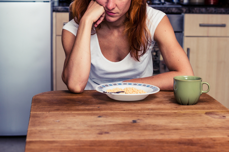 Woman does not want to eat her cereal.