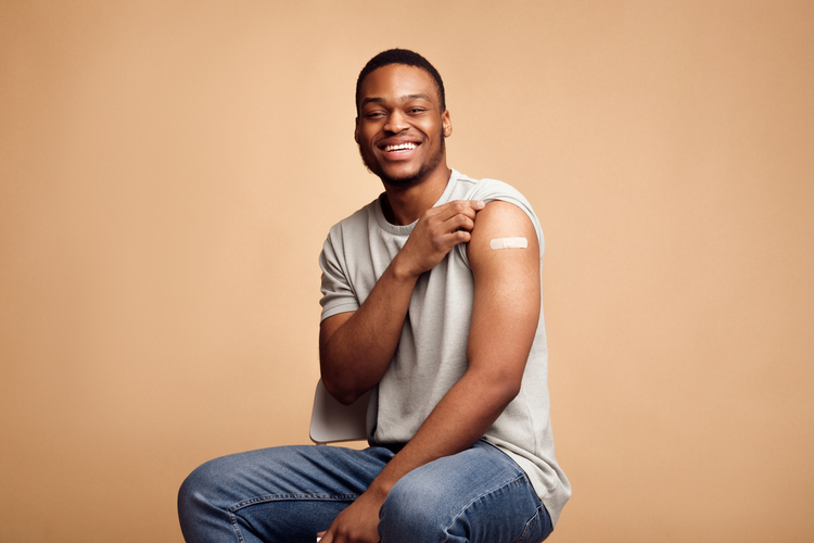 Man showing arm with plaster after getting one of covid 19 vaccines.