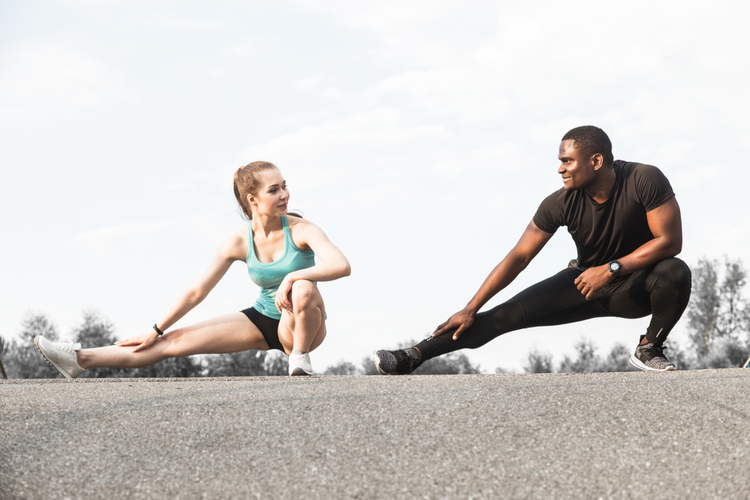 Couple athletes doing warm-up before unilateral workout.