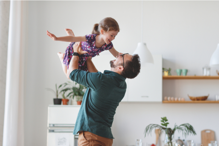 Happy family daughter hugs his dad on holiday.