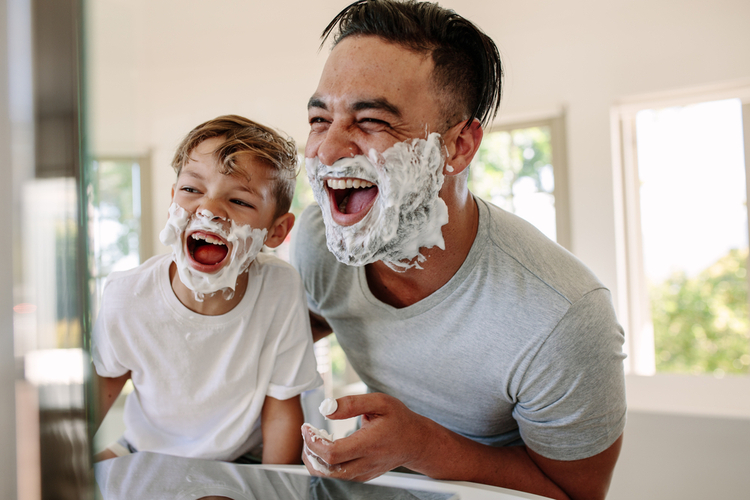 Father and son having fun while shaving in bathroom from a subscription boxes for men.