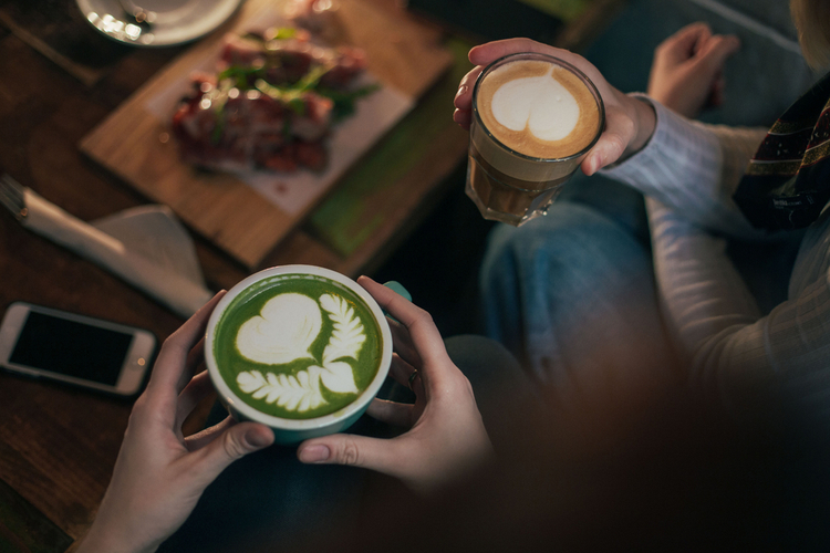 Friends enjoying matcha latte with milk and hot chocolate.